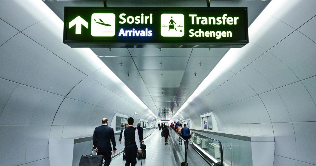 Travelers walk next to newly installed signs pointing to Schengen transfer flights areas, minutes after midnight, just after Romania's official entry into the European area of free circulation at Otopeni's "Henri Coanda" international airport on March 31, 2024. Bulgaria and Romania joined Europe's vast Schengen area of free movement on March 31, opening up travel by air and sea without border checks after a 13-year wait. A veto by Austria however means the new status will not apply to land routes, after Vienna expressed concerns over a potential influx of asylum seekers. Despite the partial membership, the lifting of controls at the two countries' air and sea borders is of significant symbolic value.,Image: 861313695, License: Rights-managed, Restrictions: , Model Release: no