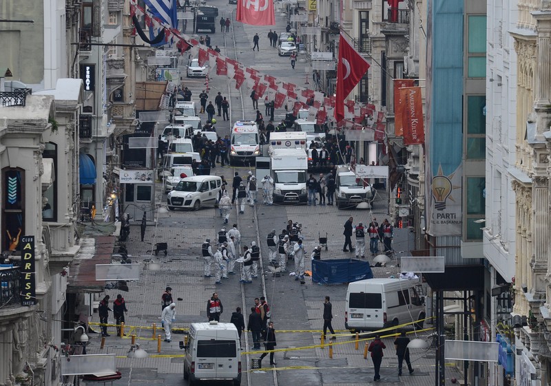 epa05220013 Crime scene Police investigator inspect the site after an explosion in Istiklal Street in Istanbul, Turkey, 19 March 2016. The exploison which happened near Taksim Square in Istiklal Street, killed at least four people and injured 20 others, according to latest reports of local media. EPA/STR