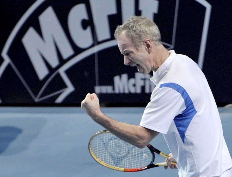 epa01205475 Former US tennis player John Mc Enroe reacts at making a point against Boris Becker of Germany during their Masters of Legends tennis match in Duesseldorf, Germany, 19 December 2007. John Mc Enroe won the match in a tie break. EPA/ACHIM SCHEIDEMANN