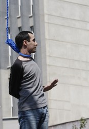 Iranian Majid Kavousifar bids farewell to his relatives before being hanged in public in central Tehran 02 August 2007. Two men convicted of murdering a top Iranian judge in 2005 were hanged in public in central Tehran, the first such public executions in the Iranian capital in five years. The men were executed for the murder of Hassan Moghaddas, a hardline deputy prosecutor and head of the "guidance" court in Tehran, who was shot dead by two men as he getting into his car in August 2005.,Image: 22078331, License: Rights-managed, Restrictions: , Model Release: no