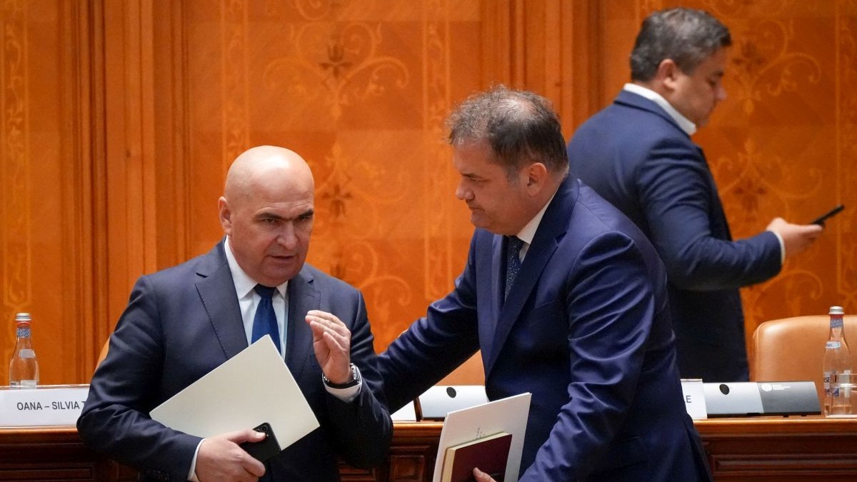 Ilie Bolojan, prim-ministrul desemnat, si Cseke Attila discuta in picioare, in timpul sedintei comune a Camerei Deputatilor si Senatului pentru votul de investire a noului Guvern, la Palatul Parlamentului din Bucuresti, 23 iunie 2025.
