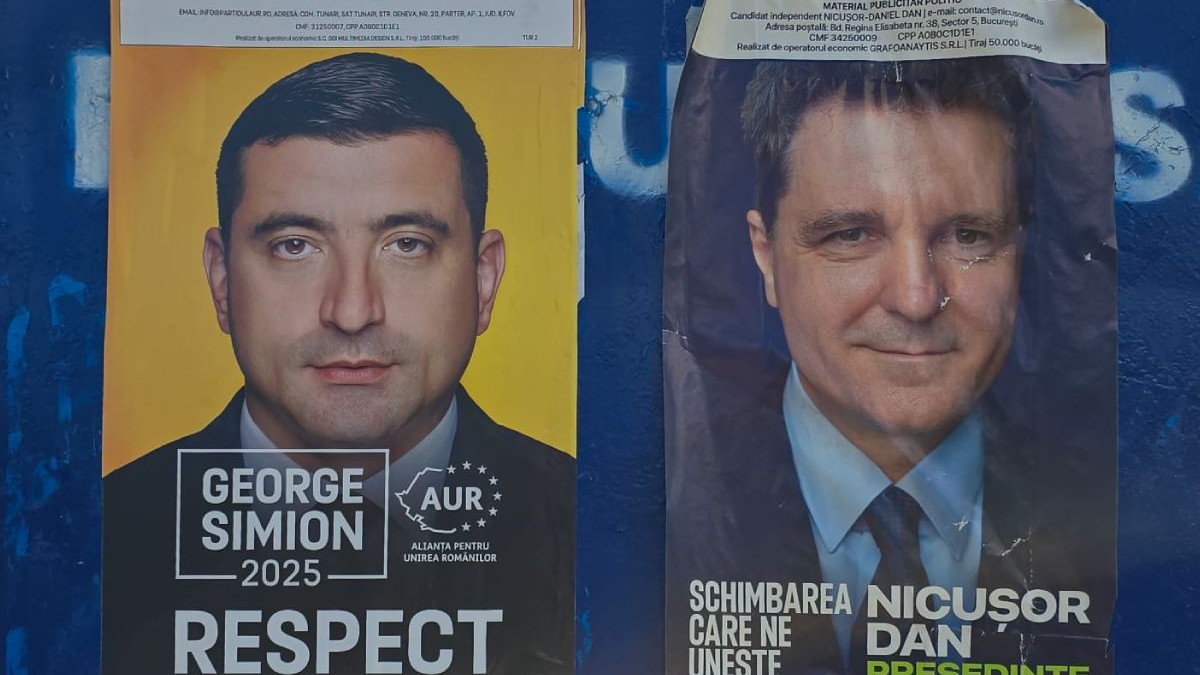 Afise electorale pe un panou albastru, George Simion in stanga, Nicușor Dan in dreapta