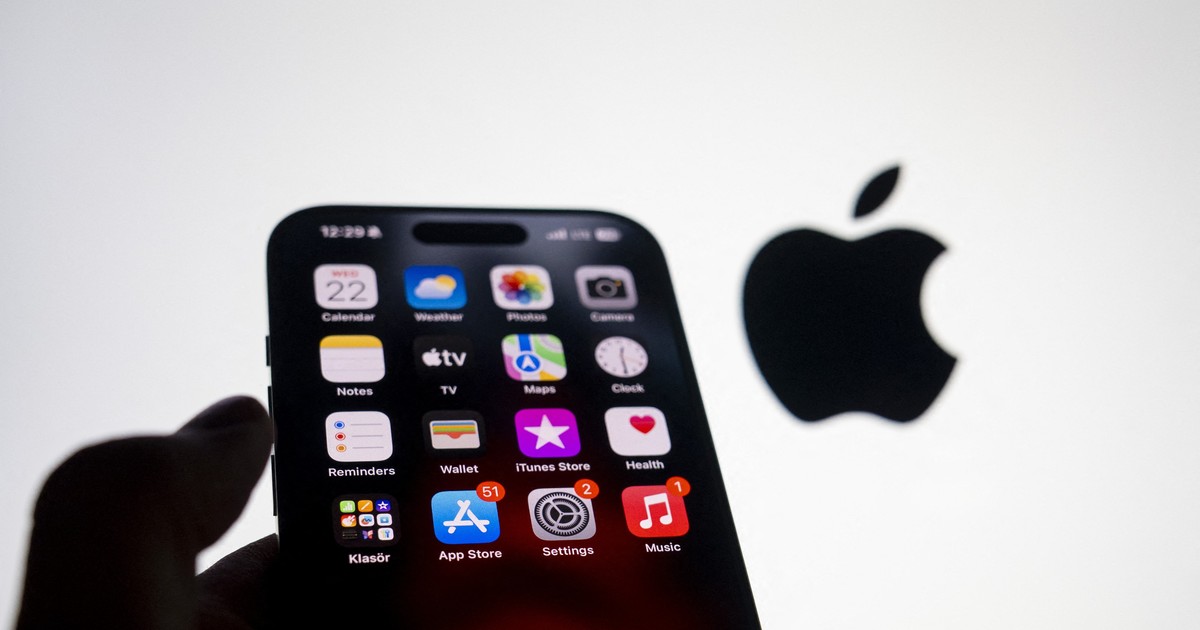 Un telefon Apple iPhone 15 Pro ținut în mână, cu logo-ul Apple pe fundal.