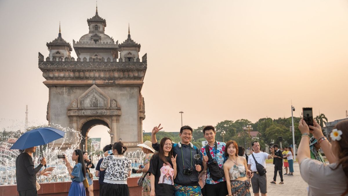 Mai mulți turiști se pozează în fața monumentului Patuxay din Vientiane, Laos, 1 mai 2024