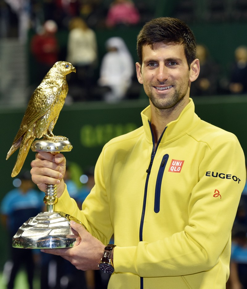 epa05094343 Novak Djokovic of Serbia poses with the trophy after winning the final match against Rafael Nadal of Spain during the Qatar ATP Open Tennis tournament at the Khalifa Tennis Squash Complex in Doha, Qatar, 09 January 2016. EPA/-