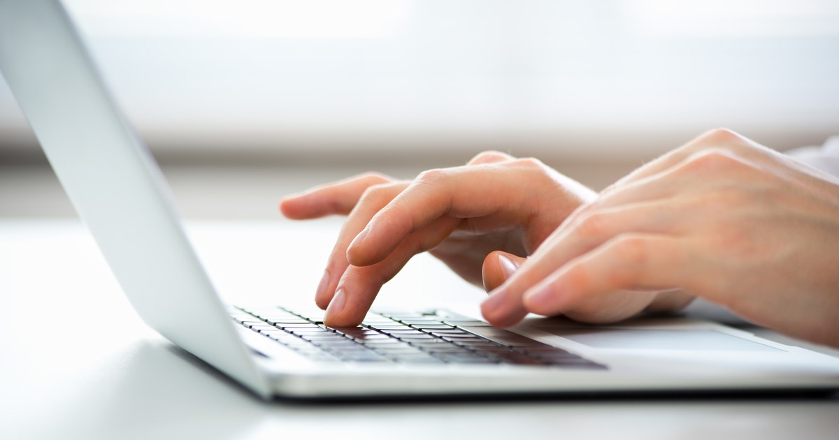 Close-up of hands of business man typing on a laptop.