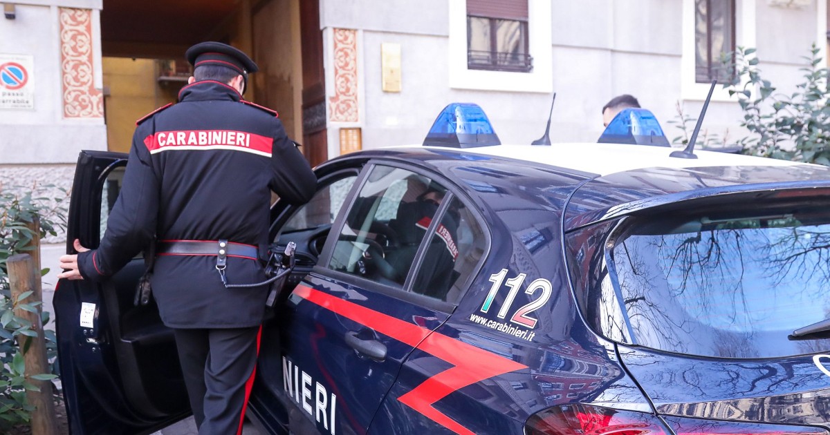 Un polițist în timp ce se urcă într-o mașină de Carabinieri, în fața unei clădiri istorice din Italia