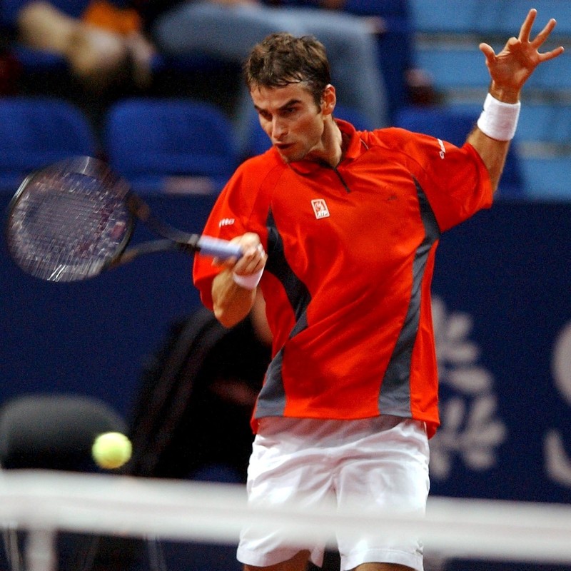 BAS101 TEN - 20021023 - BASEL, SWITZERLAND : Romanian Adrian Voinea returns a ball to Spanish Albert Costa, at the Davidoff Swiss Indoors in Basel, Switzerland, 23 October 2002. EPA PHOTO KEYSTONE/DOMINIK PLUESS