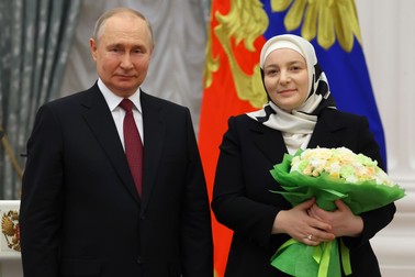Russian President Vladimir Putin, left, awards large family mother Medni Kadyrova, wife of Chechen Republic leader Ramzan Kadyrov, with the order of Mother Heroine of Russia during a State awarding ceremony at the Kremlin's St. Catherine Hall in Moscow, Russia, Tuesday, May 23, 2023. (Vyacheslav Prokofyev, Sputnik, Kremlin Pool Photo via AP)