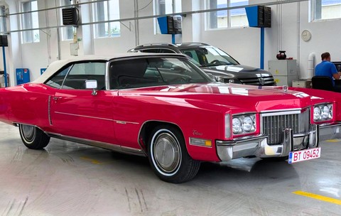 masina rosie veche conditie excelenta marca Cadillac intr-un service auto