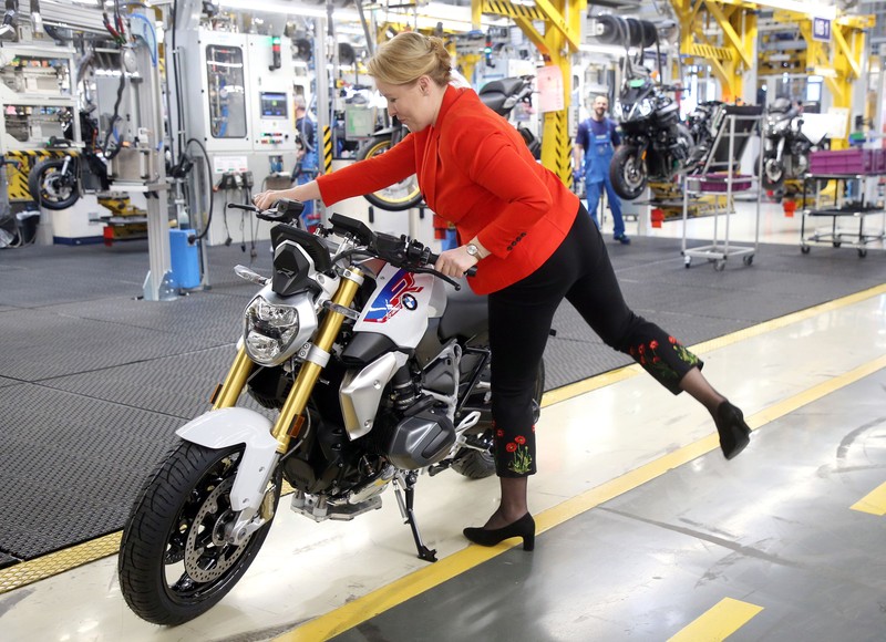 28 February 2020, Berlin: Franziska Giffey, German Minister for Family Affairs, takes a seat on a BMW R1250 R motorcycle during her visits to the BMW engine plant. Photo: Wolfgang Kumm/dpa