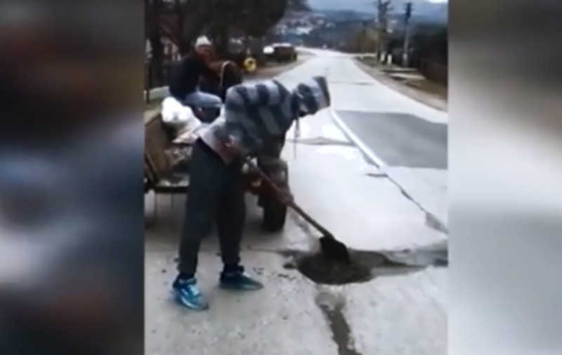 VIDEO | Oamenii s-au apucat să "plombeze" singuri un drum național! S-au săturat să aștepte "mila" autorităților