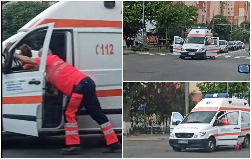 Șoferul și asistenta împing ambulanța stricată în intersecție, la Piatra Neamț. Autoutilitara are peste 1 milion de kilometri la bord