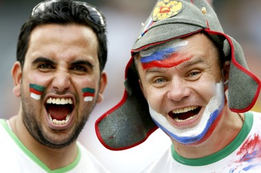 epa04284204 Supporters cheer proir to the FIFA World Cup 2014 group H preliminary round match between Algeria and Russia at the Arena da Baixada in Curitiba, Brazil, 26 June 2014. (RESTRICTIONS APPLY: Editorial Use Only, not used in association with any commercial entity - Images must not be used in any form of alert service or push service of any kind including via mobile alert services, downloads to mobile devices or MMS messaging - Images must appear as still images and must not emulate match action video footage - No alteration is made to, and no text or image is superimposed over, any published image which: (a) intentionally obscures or removes a sponsor identification image; or (b) adds or overlays the commercial identification of any third party which is not officially associated with the FIFA World Cup) EPA/RUNGROJ YONGRIT EDITORIAL USE ONLY