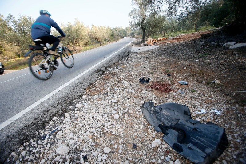epa05123247 A man rides his bike next to the spot where yesterday a car mowd down six riders of the professional cycling team Giant-Aplecion during a training session in Benigembla, Alicante, easter Spain, 24 January 2016. Two of the riders remain in hospital while the other four have been discharged. EPA/MANUEL LORENZO