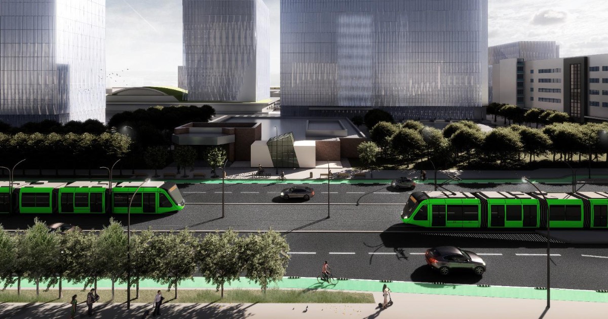 Imaginea este o randare digitală care prezintă un peisaj urban modern, dominat de zgârie-nori înalți, cu fațade din sticlă, și o arteră principală de circulație. Pe drumul larg, mărginit de piste verzi pentru biciclete și spații verzi, circulă două tramvaie verzi moderne și câteva mașini, sugerând un proiect de dezvoltare urbanistică axat pe transportul public și pietoni.