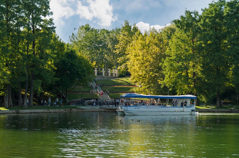 Bucharest, ROMANIA - August 14 2016: People taking a tour of the park on a boat or strolling through IOR park. BUCHAREST -August 14 2016