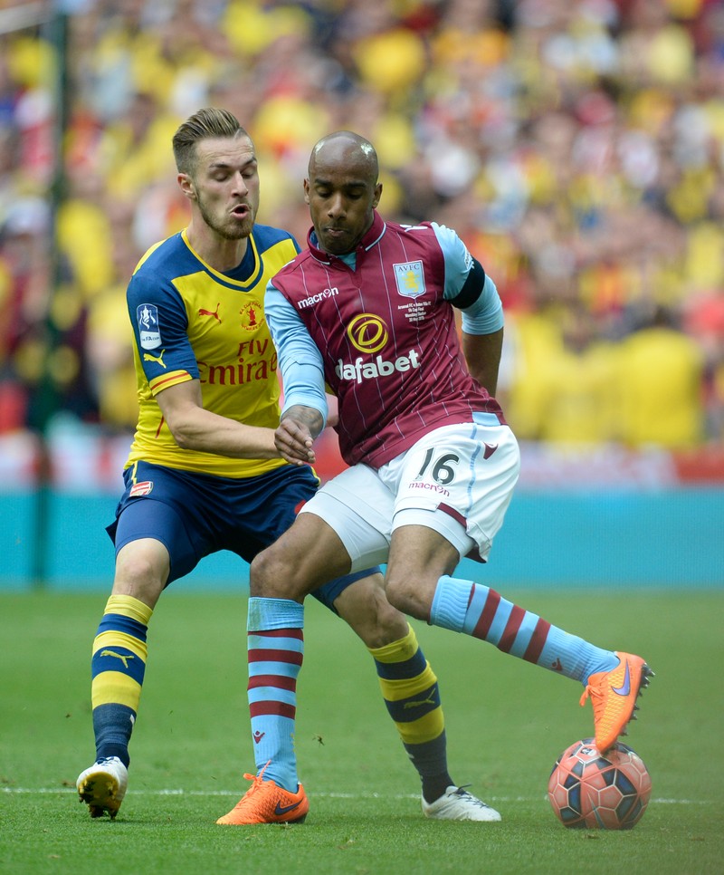 epa04776426 Arsenal's Aaron Ramsey (L) vies for the ball against Aston Villa Fabian Delph (R) during the FA Cup Final soccer match between Arsenal and Aston Villa at Wembley stadium in London, Britain, 30 May 2015. EPA/FACUNDO ARRIZABALAGA DataCo terms and conditions apply. http://www.epa.eu/files/Terms%20and%20Conditions/DataCo_Terms_and_Conditions.pdf