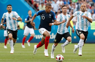 epa06851810 Kylian Mbappe (C) of France and Javier Mascherano (R) of Argentina in action during the FIFA World Cup 2018 round of 16 soccer match between France and Argentina in Kazan, Russia, 30 June 2018. (RESTRICTIONS APPLY: Editorial Use Only, not used in association with any commercial entity - Images must not be used in any form of alert service or push service of any kind including via mobile alert services, downloads to mobile devices or MMS messaging - Images must appear as still images and must not emulate match action video footage - No alteration is made to, and no text or image is superimposed over, any published image which: (a) intentionally obscures or removes a sponsor identification image; or (b) adds or overlays the commercial identification of any third party which is not officially associated with the FIFA World Cup) EPA-EFE/DIEGO AZUBEL EDITORIAL USE ONLY