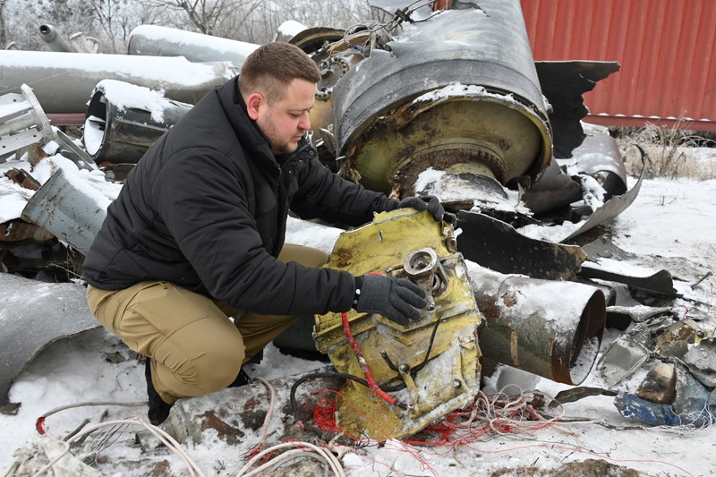 In this photo, taken on January 6, 2024, a prosecutor's office expert inspects remains of a missile used during an attack on Kharkiv on January 2.,Image: 834705508, License: Rights-managed, Restrictions: , Model Release: no