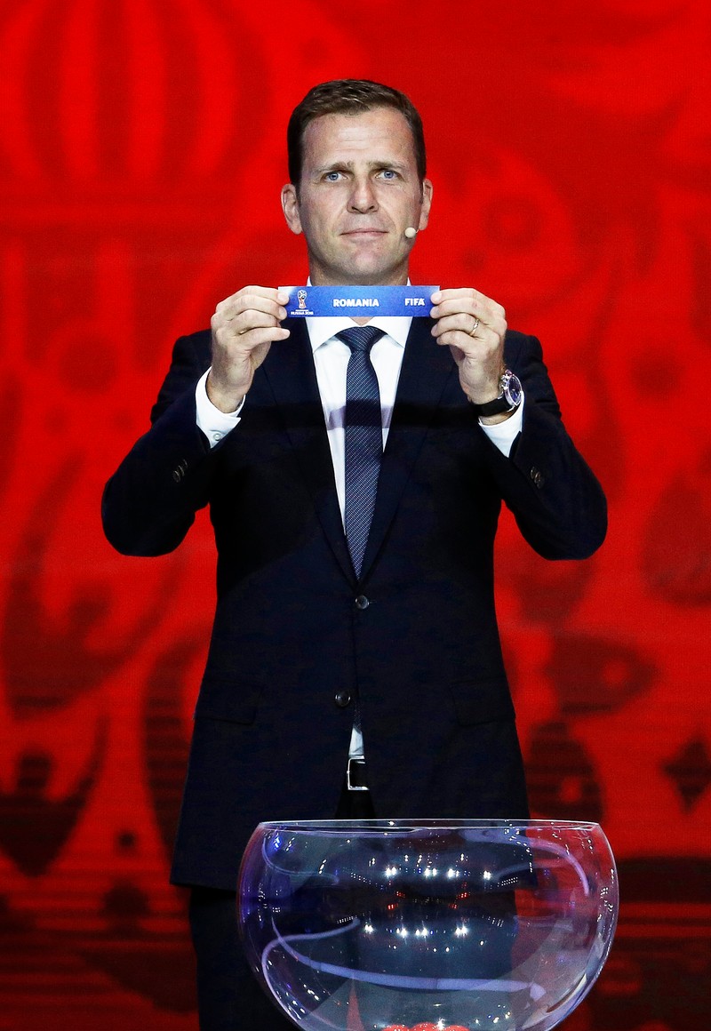 epa04860427 Draw assistant Oliver Bierhoff of Germany shows the ticket of Romania during the European Zone Preliminary Draw of the FIFA World Cup 2018 at Konstantinovsky palace outside St.Petersburg, Russia, 25 July 2015. St.Petersburg is one of the host cities of the FIFA World Cup 2018 in Russia which will take place from 14 June until 15 July 2018. EPA/MAXIM SHIPENKOV