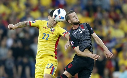 epaselect epa05377927 Cristian Sapunaru (L) of Romania in action against Ermir Lenjani of Albania during the UEFA EURO 2016 group A preliminary round match between Romania and Albania at Stade de Lyon in Lyon, France, 19 June 2016. (RESTRICTIONS APPLY: For editorial news reporting purposes only. Not used for commercial or marketing purposes without prior written approval of UEFA. Images must appear as still images and must not emulate match action video footage. Photographs published in online publications (whether via the Internet or otherwise) shall have an interval of at least 20 seconds between the posting.) EPA/YURI KOCHETKOV EDITORIAL USE ONLY
