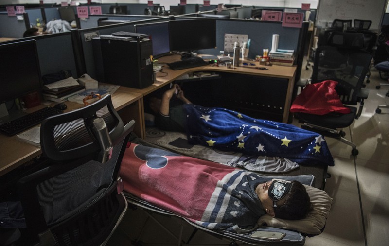 Secretul productivității în China: tradiția somnului de prânz pe care marile companii o încurajează, iar angajații aduc la birou paturi pliabile și perne