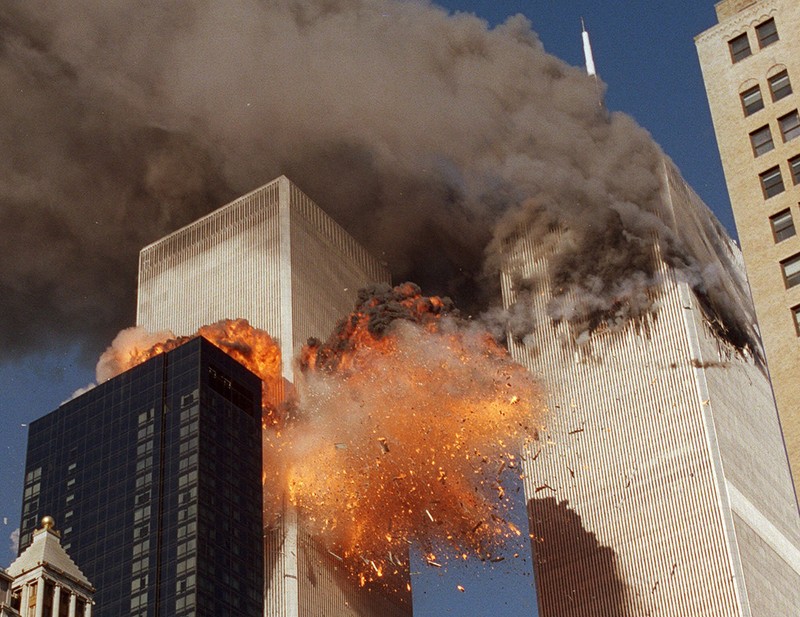 ** FOR USE AS DESIRED WITH SEPT. 11 ANNIVERSARY STORIES--FILE **Smoke billows from one of the towers of the World Trade Center and flames as debris explodes from the second tower, in this Sept. 11, 2001, file photo. In one of the most horrifying attacks ever against the United States, terrorists crashed two airliners into the World Trade Center in a deadly series of blows that brought down the twin 110-story towers. This year will mark the fifth anniversary of the attacks. (AP Photo/Chao Soi Cheong/FILE)