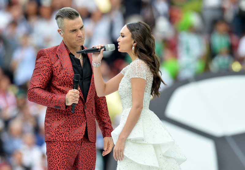 epa06807221 English singer Robbie Williams and Russian soprano Aida Garifullina perform during the opening ceremony prior to the FIFA World Cup 2018 group A preliminary round soccer match between Russia and Saudi Arabia in Moscow, Russia, 14 June 2018. (RESTRICTIONS APPLY: Editorial Use Only, not used in association with any commercial entity - Images must not be used in any form of alert service or push service of any kind including via mobile alert services, downloads to mobile devices or MMS messaging - Images must appear as still images and must not emulate match action video footage - No alteration is made to, and no text or image is superimposed over, any published image which: (a) intentionally obscures or removes a sponsor identification image; or (b) adds or overlays the commercial identification of any third party which is not officially associated with the FIFA World Cup) EPA-EFE/PETER POWELL EDITORIAL USE ONLY EDITORIAL USE ONLY