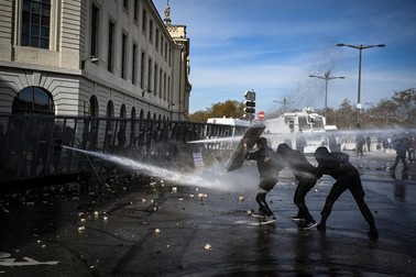 Police spray water cannons at protesters during clashes on the sidelines of a demonstration after the government pushed a pensions reform through parliament without a vote, using the article 49.3 of the constitution, in Lille, northern France, on March 28, 2023. France faces another day of strikes and protests nearly two weeks after the president bypassed parliament to pass a pensions overhaul that is sparking turmoil in the country, with unions vowing no let-up in mass protests to get the government to back down. The day of action is the tenth such mobilisation since protests started in mid-January against the law, which includes raising the retirement age from 62 to 64.,Image: 765697053, License: Rights-managed, Restrictions: , Model Release: no
