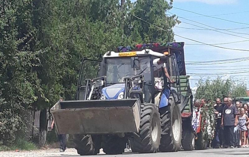 FOTO/ Băiețelul din Dolj ucis în somn de mama sa a fost înmormântat în comuna Unirea, unde a avut loc tragedia. Sicriul, purtat pe un buldotractor