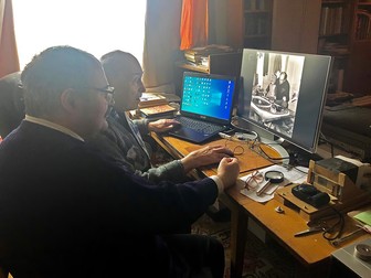 Mircea Pauca, stânga, se uită împreună cu tatăl sau la fotografii din arhiva familiei