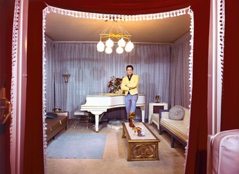 Mar. 7, 1965 - Memphis, TN, U.S. - Elvis Presley at his piano inside Graceland in this photograph made for the March 7, 1965 in the first issue of Mid-South, the former Sunday magazine of The Commercial Appeal. Elvis had misgivings about allowing pictures to be made inside his home. ''It's not that I don't want pictures,'' he said. ''You know what I mean. Some people might think I am looking for publicity or trying to exploit my home. I certainly don't want anyone to think that.