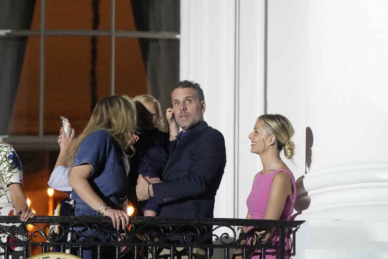 epa10052655 Hunter Biden (C) joins United States President Joe Biden and first lady Dr. Jill Biden as they watch fireworks from the Truman Balcony of the White House in Washington, DC, USA, 04 July 2022. Earlier the President made remarks on patriotism and on the mass shootings in Highland Park, Illinois. EPA-EFE/Chris Kleponis / POOL