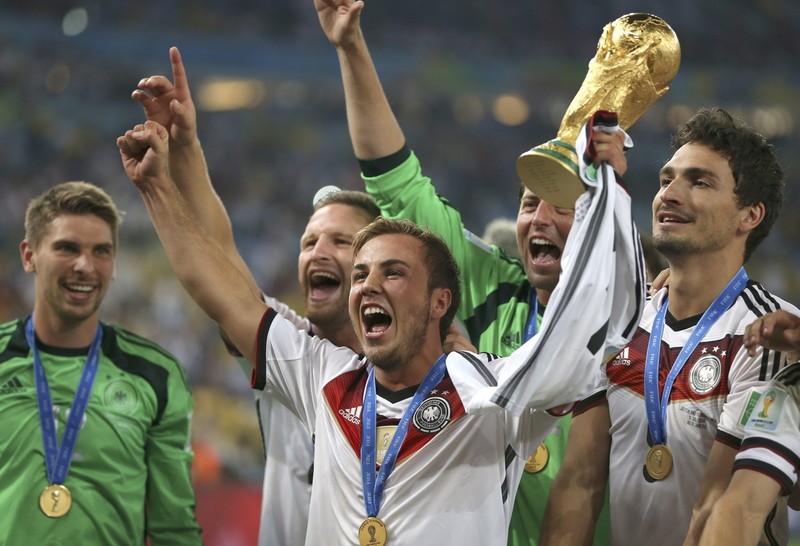epa04315063 German player Mario Goetze holds the World Cup trophy after the FIFA World Cup 2014 final between Germany and Argentina at the Estadio do Maracana in Rio de Janeiro, Brazil, 13 July 2014. Germany won 1-0 and Goetze scored the winning goal. (RESTRICTIONS APPLY: Editorial Use Only, not used in association with any commercial entity - Images must not be used in any form of alert service or push service of any kind including via mobile alert services, downloads to mobile devices or MMS messaging - Images must appear as still images and must not emulate match action video footage - No alteration is made to, and no text or image is superimposed over, any published image which: (a) intentionally obscures or removes a sponsor identification image; or (b) adds or overlays the commercial identification of any third party which is not officially associated with the FIFA World Cup) EPA/Marcelo Sayao EDITORIAL USE ONLY