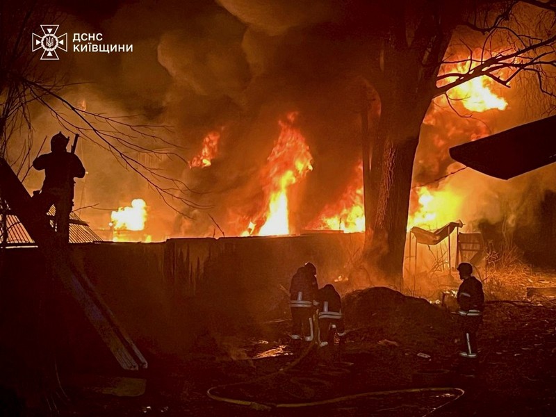 In this photo provided by the Ukrainian Emergency Service, firefighters put out the fire following a Russian attack in near Kyiv, Ukraine, Sunday, March 23, 2025.,Image: 978246396, License: Rights-managed, Restrictions: This content is intended for editorial use only. For other uses, additional clearances may be required. Handout - Government Produced AP PROVIDES ACCESS TO THIS PUBLICLY DISTRIBUTED HANDOUT PHOTO PROVIDED BY UKRAINIAN EMERGENCY SERVICE PRESS OFFICE MANDATORY CREDIT., Model Release: no