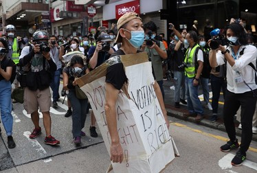 epa08650141 A protester wearing a cardboard sign takes part in a rally against the postponement of the Legislative Council Elections in Hong Kong, China, 06 September 2020. Activists answered online calls to protest on the day the Legislative Council polls were due to be held on 06 September 2020 until the government postponed them for a year, citing Covid-19 and the risk to public health. EPA-EFE/JEROME FAVRE