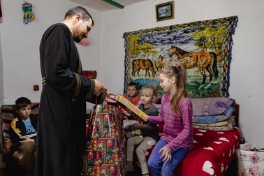 Părintele Alexandru Balaban a venit încărcat cu daruri pentru Iulian și frații lui