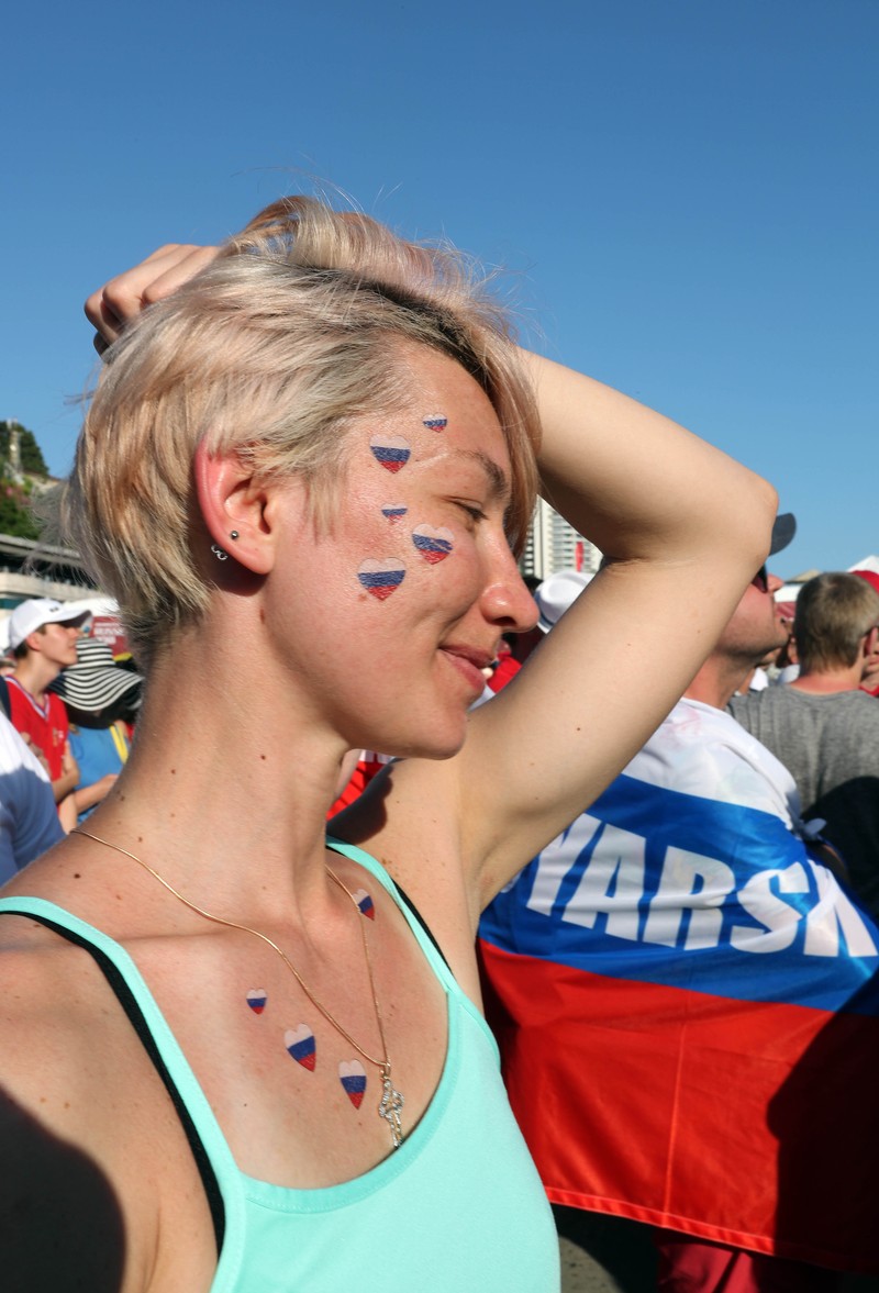 epa06807542 A Russia's fan watches a live broadcast of the FIFA World Cup 2018 Group A preliminary round soccer match between Russia and Saudi Arabia in the fan zone in Sochi, Russia, 14 June 2018. The FIFA World Cup 2018 will take place in Russia from 14 June until 15 July 2018. EPA-EFE/MOHAMED MESSARA