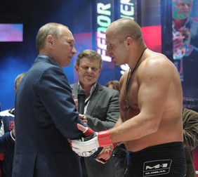 Prime Minister Vladimir Putin, left, congratulates Russia's Fedor Emelianenko on his win over the United States' Jeff Monson at the M-1 Global mixed martial arts tournament match at Moscow's Olimpiysky Sports Complex, November 20, 2011.