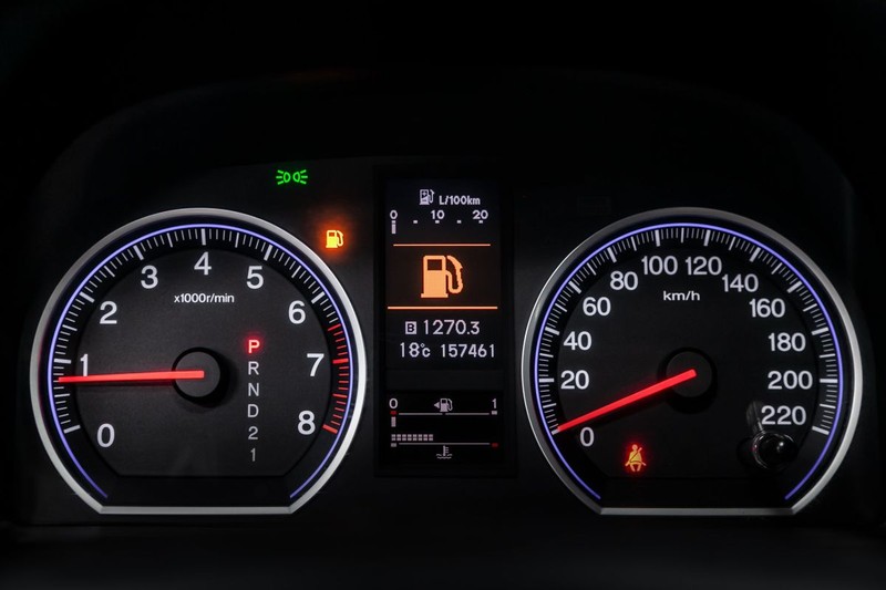 Interior view of car with black salon. Modern luxury prestige car interior: speedometer, dashboard and tachometer with white backlight and other buttons.Soft focus