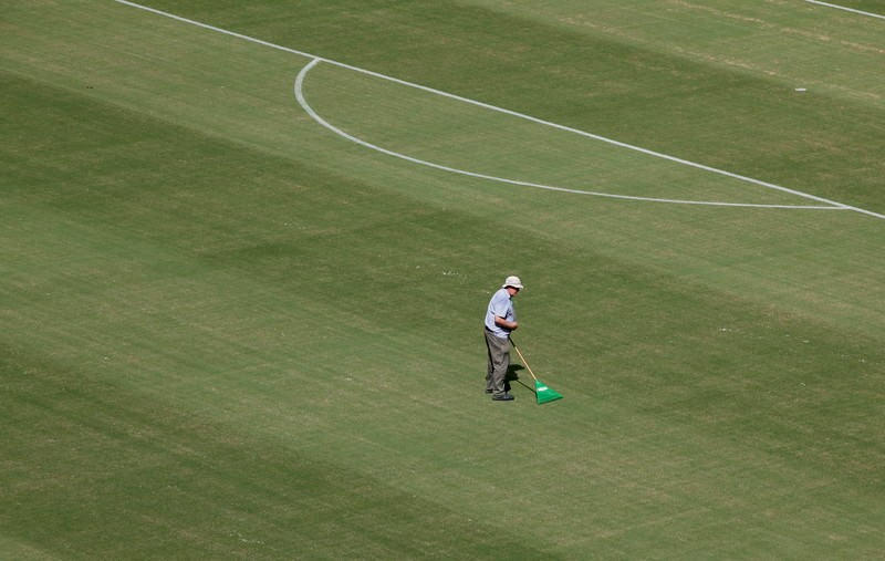 epa04252104 Ground staff looks after the pitch in the Arena Amazonia stadium in Manaus, Brazil, 12 June 2014. The stadium will host the FIFA World Cup 2014 match between Italy and England on 14 June. (RESTRICTIONS APPLY: Editorial Use Only, not used in association with any commercial entity - Images must not be used in any form of alert service or push service of any kind including via mobile alert services, downloads to mobile devices or MMS messaging - Images must appear as still images and must not emulate match action video footage - No alteration is made to, and no text or image is superimposed over, any published image which: (a) intentionally obscures or removes a sponsor identification image; or (b) adds or overlays the commercial identification of any third party which is not officially associated with the FIFA World Cup) EPA/JEON HEON-KYUN EDITORIAL USE ONLY