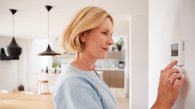 femeie care reglează temperatura in propria casă