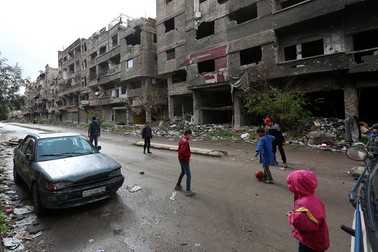Copiii se joacă în tabăra de refugiați Al-Yarmouk de lângă Damasc, Siria. Foto EPA