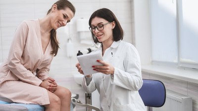 Woman,Doctor,Look,Microscope,At,Gynecologist's,Appointment.,Female,Gynecologist,Examining