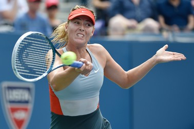 epa04378045 Maria Sharapova of Russia hits a return to Caroline Wozniacki of Denmark during the seventh day of the 2014 US Open Tennis Championship at the USTA National Tennis Center in Flushing Meadows, New York, USA, 31 August 2014. The US Open runs through 08 September, a 15-day schedule. EPA/JOHN G. MABANGLO