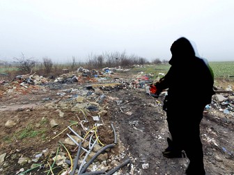 Unul dintre oamenii care lucrează pe câmpul dintre cele două localități arată parcelele pline de gunoaie