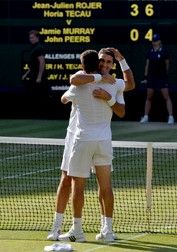 epa04842832 Horia Tecau (facing) of Romania and Jean-Julien Rojer of the Netherlands celebrate winning the Men's doubles final match against Jamie Murray of Britain and John Peers of Australia during the Wimbledon Championships at the All England Lawn Tennis Club, in London, Britain, 11 July 2015. EPA/ANDY RAIN EDITORIAL USE ONLY/NO COMMERCIAL SALES