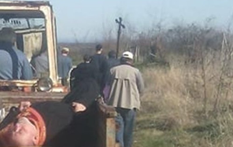 FOTO | Un preot în stare de ebrietate a fost pus de săteni lângă un sicriu și cărat într-o remorcă până la cimitir
