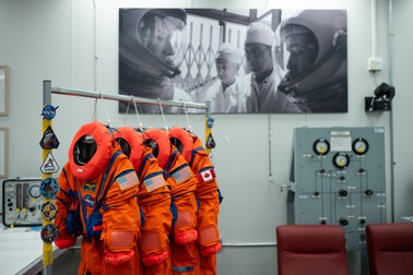 The Orion Crew Survival System suits that Commander Reid Wiseman, Pilot Victor Glover, and Mission Specialist Christina Koch from NASA, and Mission Specialist Jeremy Hansen from the CSA (Canadian Space Agency) will wear on the Artemis II test flight are seen in the suit-up room of the Neil A. Armstrong Operations and Checkout Building, Saturday, Jan. 17, 2026, at NASA’s Kennedy Space Center in Florida. NASA’s Artemis II test flight will take Wiseman, Glover, Koch, and Hansen around the Moon and back to Earth no later than April 2026. Photo Credit: (NASA/Joel Kowsky)